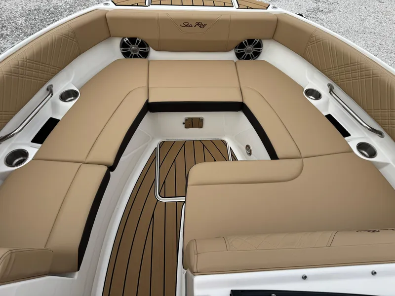 Slide: The Image of 2025 Sea Ray SDX 250 boat interior with tan seating and wood accents. - 13