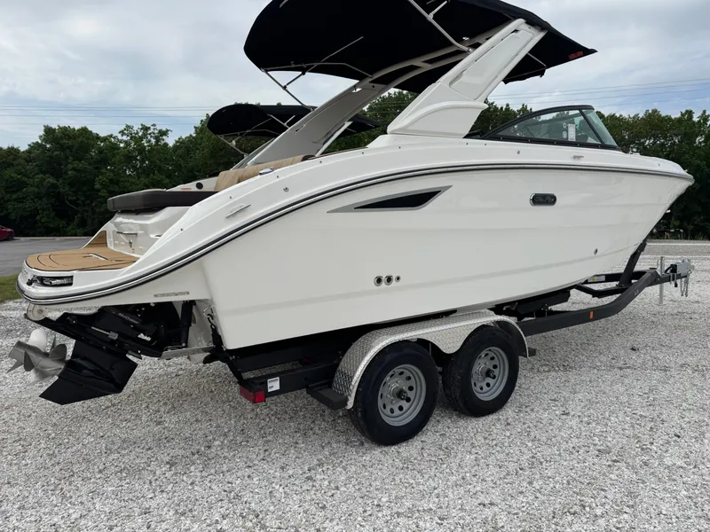 Slide: The Image of 2025 Sea Ray SDX 250 boat on trailer, sleek design, white exterior, dual axles. - 2