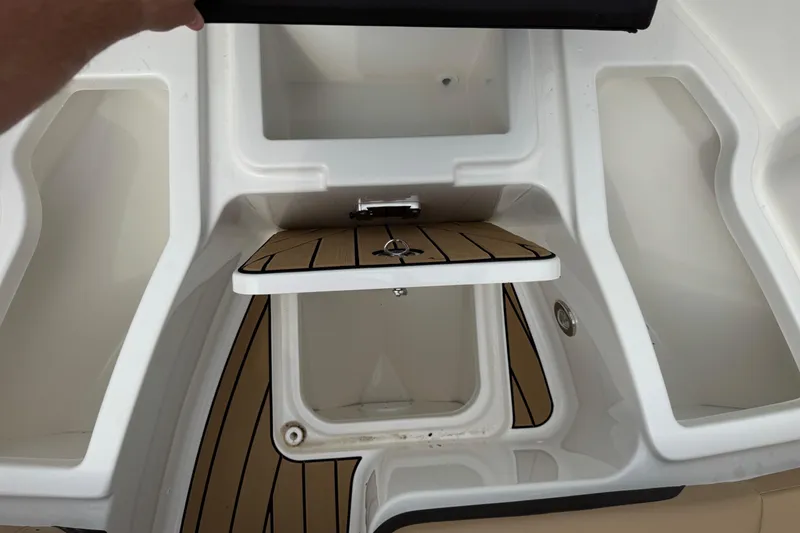 Slide: The Image of 2025 Sea Ray SDX 250 boat storage compartments with teak flooring. - 21