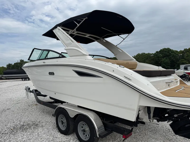 Slide: The Image of 2025 Sea Ray SDX 250 boat on trailer with canopy, parked on gravel. - 4