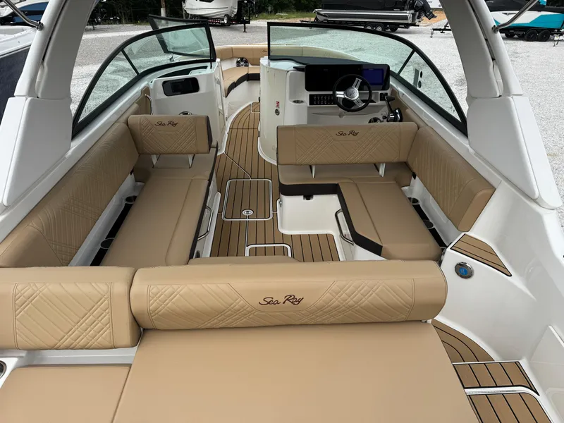 Slide: The Image of 2025 Sea Ray SDX 250 boat interior with tan seating and modern dashboard. - 7