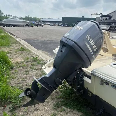 Slide: The Image of 2014 Scout 175 Sportfish with Yamaha outboard motor in a boatyard setting. - 4