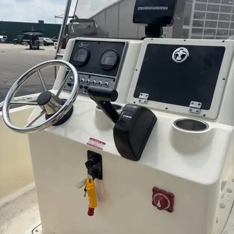 Slide: The Image of 2014 Scout 175 Sportfish boat console with steering wheel and controls. - 8