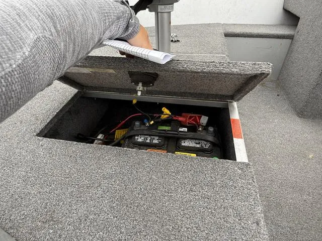 Slide: The Image of 2007 Alumacraft Lunker 165CS boat battery compartment with open hatch. - 5