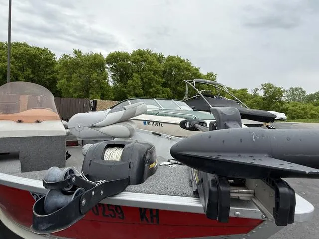 Slide: The Image of 2007 Alumacraft Lunker 165CS boat with equipment, parked outdoors near trees. - 7