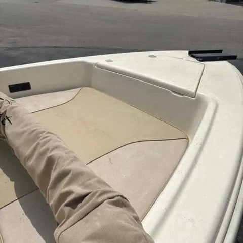 Slide: The Image of 2014 Scout 175 Sportfish boat deck with beige seating and storage compartment. - 12