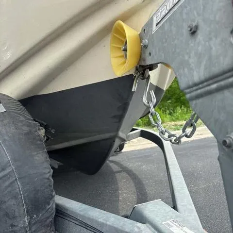 Slide: The Image of 2014 Scout 175 Sportfish boat on trailer, secured with chain and yellow roller. - 3