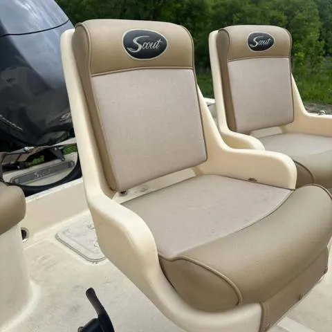 Slide: The Image of 2014 Scout 175 Sportfish boat seats, beige and cream, with logo, outdoors. - 6
