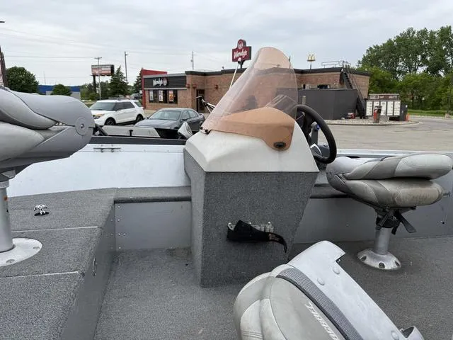 Slide: The Image of 2007 Alumacraft Lunker 165CS boat interior with seats and steering wheel in a parking lot. - 10