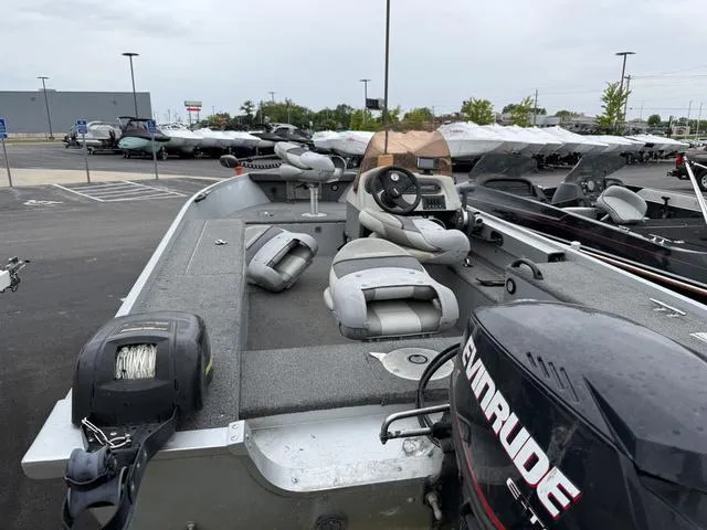 Slide: The Image of 2007 Alumacraft Lunker 165CS boat with Evinrude motor, parked in a lot. - 12