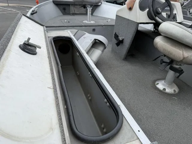 Slide: The Image of 2007 Alumacraft Lunker 165CS boat interior with open storage compartment and seating. - 3