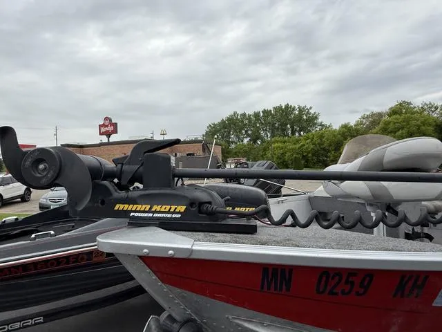 Slide: The Image of 2007 Alumacraft Lunker 165CS boat with Minn Kota trolling motor, parked outdoors. - 6