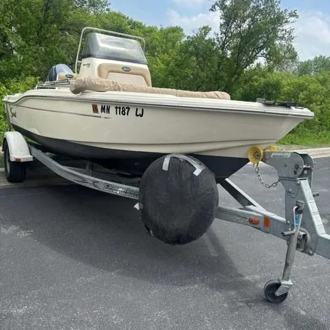 Slide: The Image of 2014 Scout 175 Sportfish boat on trailer, parked outdoors. - 2