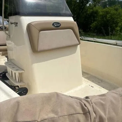 Slide: The Image of 2014 Scout 175 Sportfish boat interior with console and seating, outdoors. - 9