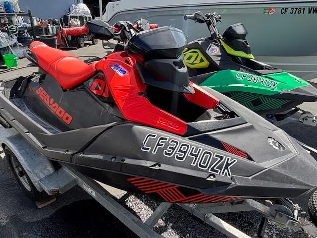 Slide: The Image of 2021 Sea-Doo SPARK TRIXX 3up jet ski on trailer, vibrant red and black design. - 3