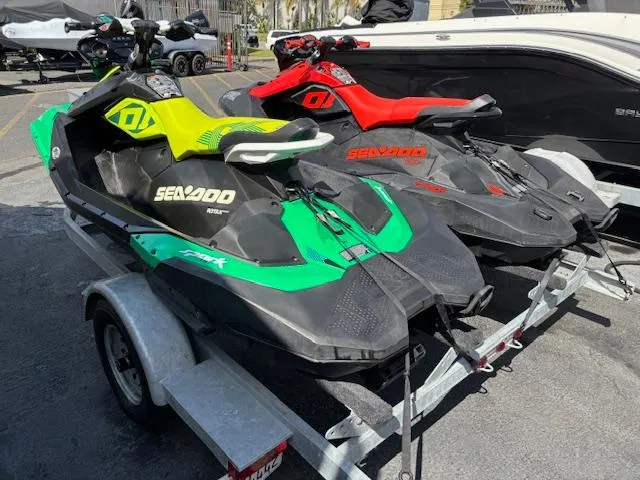 Slide: The Image of 2021 Sea-Doo SPARK TRIXX 3up jet skis on trailer, green and red models. - 7