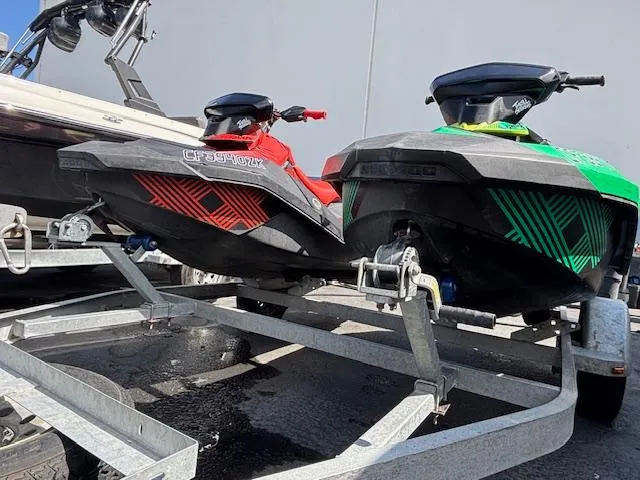Slide: The Image of 2021 Sea-Doo SPARK TRIXX 3up jet skis on a trailer, red and green models. - 8