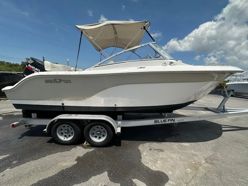 The Image of 2008 Sea Fox 216 DC boat on trailer under clear blue sky. - 0