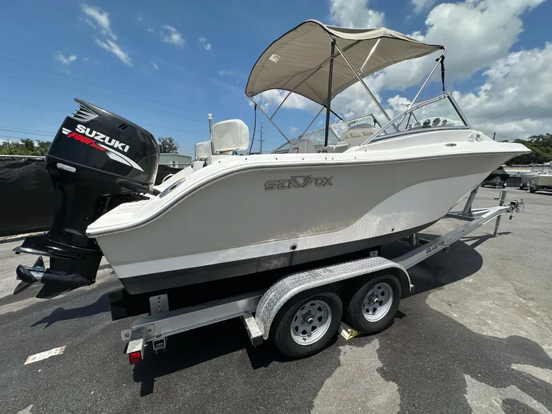 Slide: The Image of 2008 Sea Fox 216 Dual Console boat on trailer, parked outdoors under clear sky. - 2