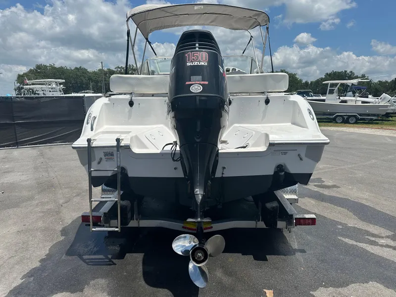 Slide: The Image of 2008 Sea Fox 216 Dual Console boat with Suzuki engine on trailer, under clear blue sky. - 3