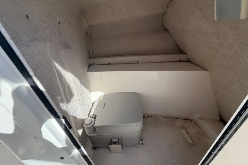 Slide: The Image of Interior of 2008 Sea Fox 216 Dual Console boat with portable toilet. - 31