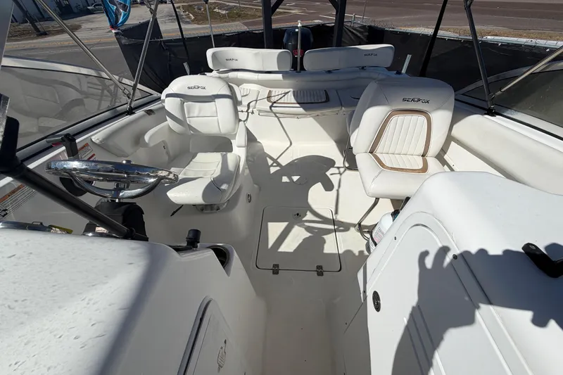 Slide: The Image of 2008 Sea Fox 216 Dual Console boat interior with white seating and steering wheel. - 42