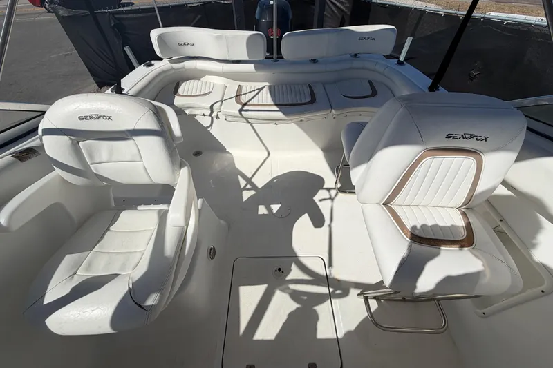 Slide: The Image of 2008 Sea Fox 216 Dual Console boat interior with white seating and spacious layout. - 44