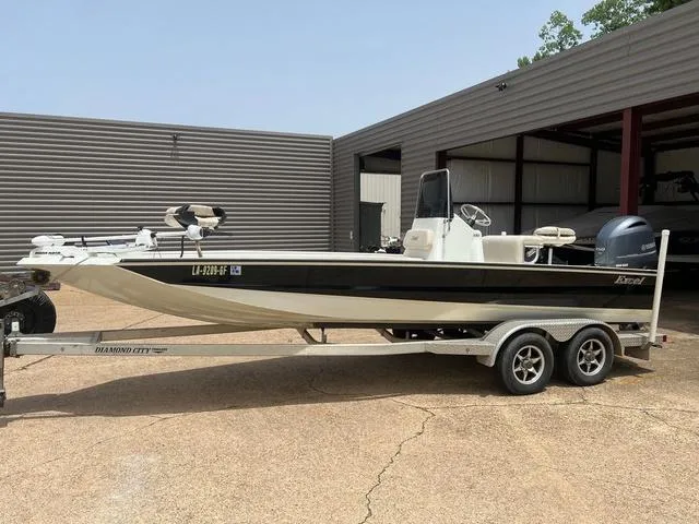 Slide: The Image of 2017 Excel 22' Pleasure boat on trailer, parked outside a garage. - 1