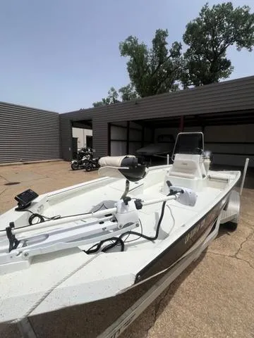 Slide: The Image of 2017 Excel 22' Pleasure boat in storage, featuring a trolling motor and open deck. - 3