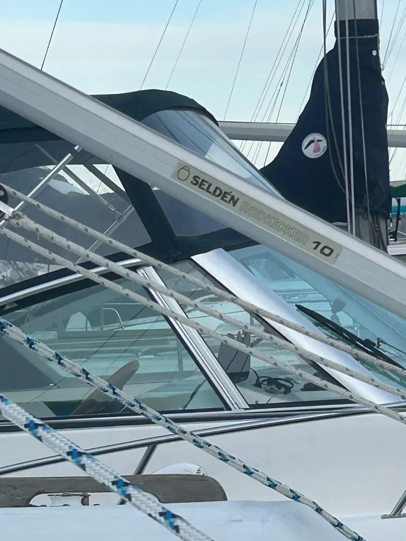 Slide: The Image of 1973 Challenger Cruiser sailboat with Selden rigging, docked at a marina. - 13