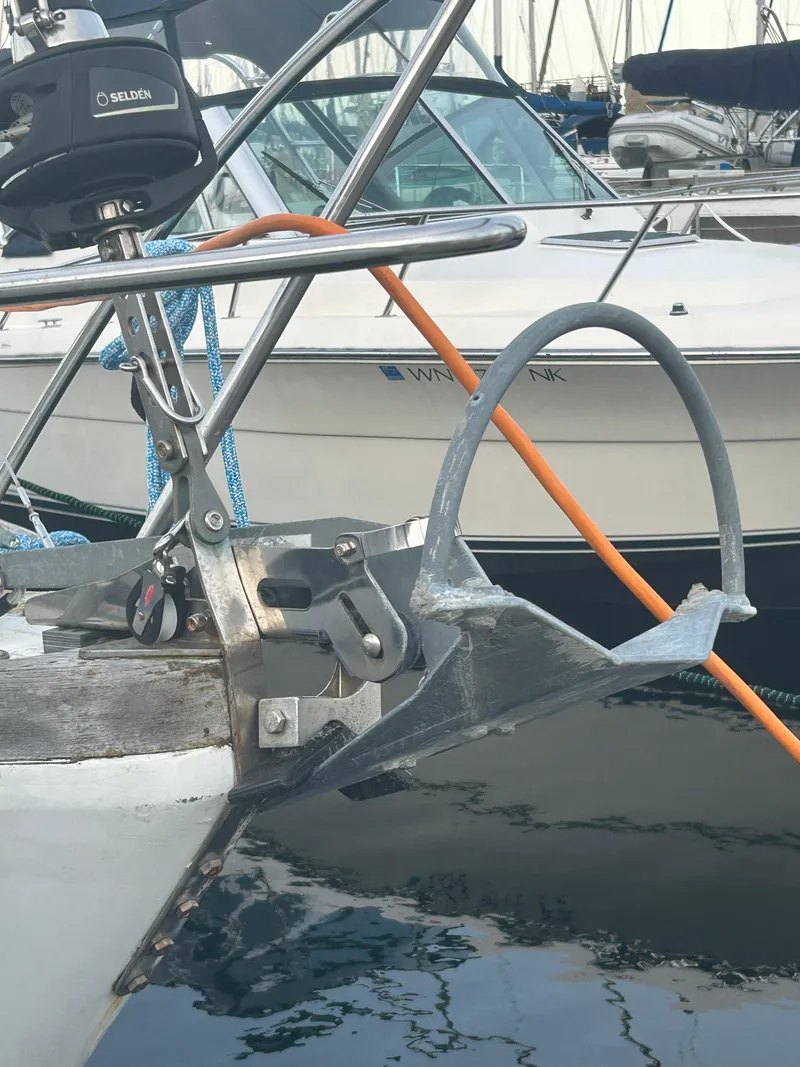 Slide: The Image of 1973 Challenger Cruiser boat with anchor and railing at marina. - 14
