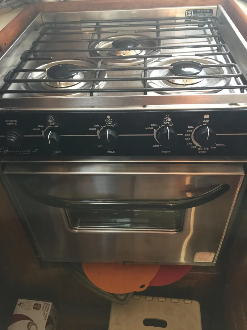 Slide: The Image of 1973 Challenger Cruiser stove with four burners and oven, featuring vintage design and controls. - 26