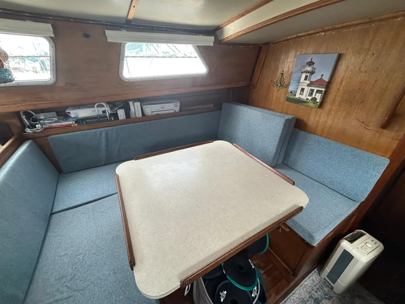 Slide: The Image of 1973 Challenger Cruiser interior with blue seating, table, and wall art. - 29