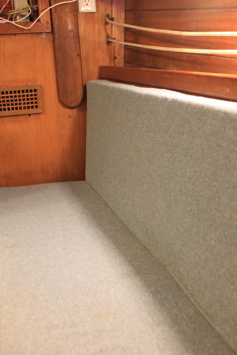 Slide: The Image of 1973 Challenger Cruiser interior with wooden paneling and cushioned seating. - 30