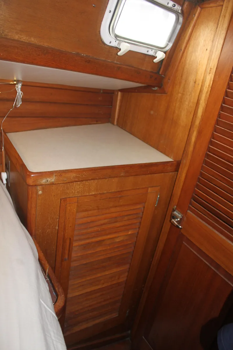 Slide: The Image of 1973 Challenger Cruiser interior with wooden cabinetry and small window. - 31