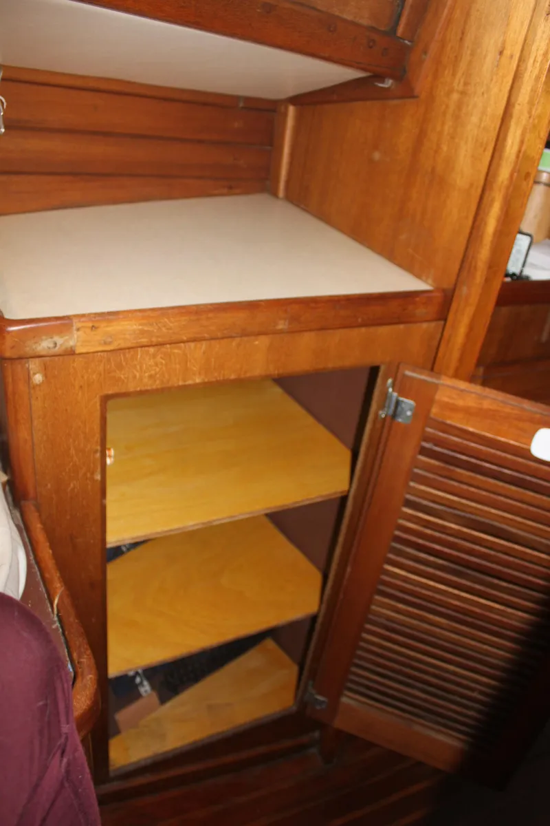 Slide: The Image of 1973 Challenger Cruiser wooden cabinet with open shelves and louvered door. - 32