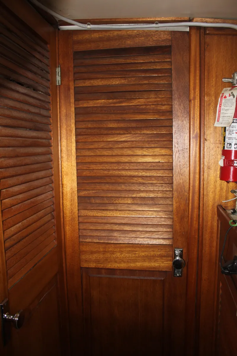 Slide: The Image of 1973 Challenger Cruiser interior with wooden louvered door and fire extinguisher. - 33