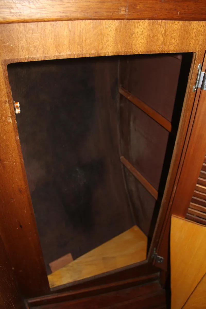 Slide: The Image of 1973 Challenger Cruiser interior wooden cabinet with open door and shelves. - 34