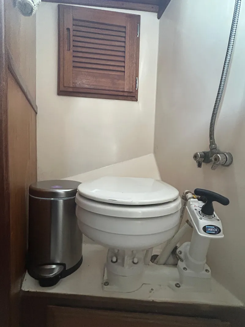 Slide: The Image of 1973 Challenger Cruiser marine toilet with manual pump and stainless steel trash can. - 37
