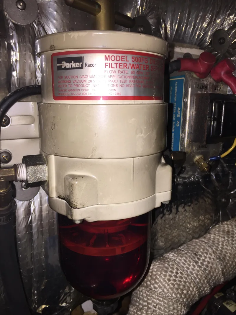 Slide: The Image of Parker Racor fuel filter/water separator in a 1973 Challenger Cruiser engine compartment. - 43