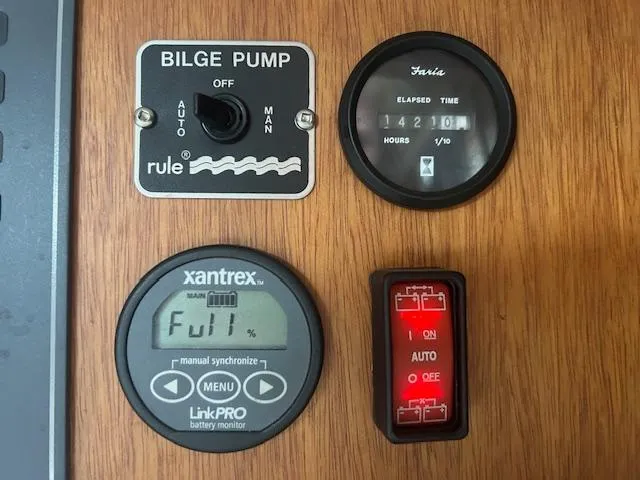 Slide: The Image of 1973 Challenger Cruiser control panel with bilge pump, battery monitor, and elapsed time gauge. - 49