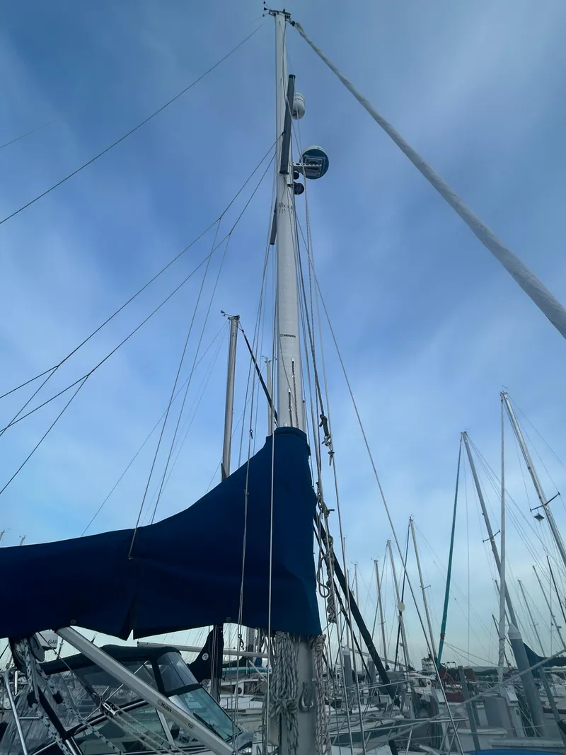 Slide: The Image of Sailboat mast against blue sky, 1973 Challenger Cruiser in marina. - 8