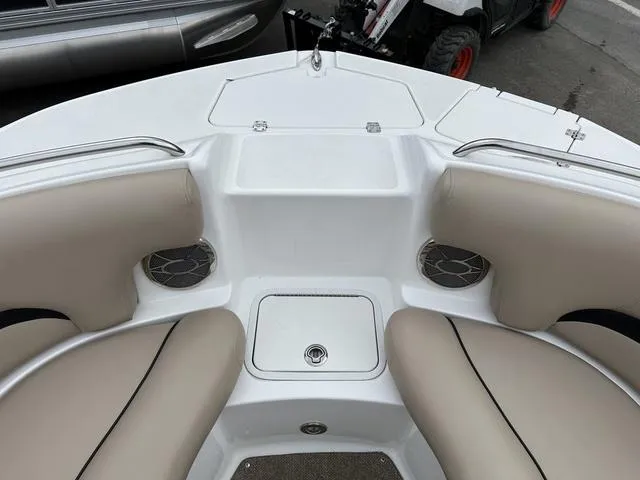 Slide: The Image of 2015 Hurricane SD 2400 I/O boat interior with beige seating and storage compartments. - 12