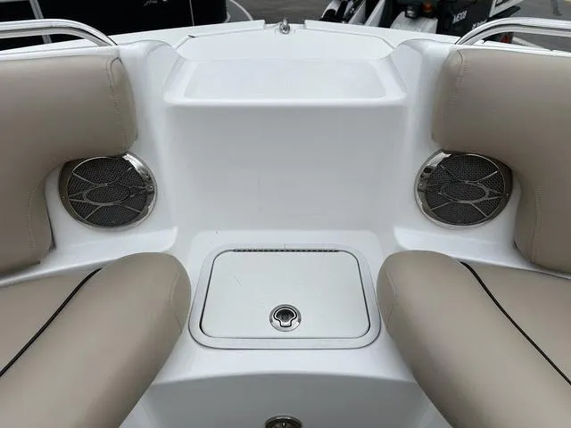 Slide: The Image of 2015 Hurricane SD 2400 I/O boat interior with beige seating and built-in speakers. - 13