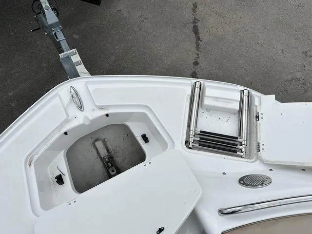 Slide: The Image of 2015 Hurricane SD 2400 I/O boat bow with storage compartment and ladder. - 14