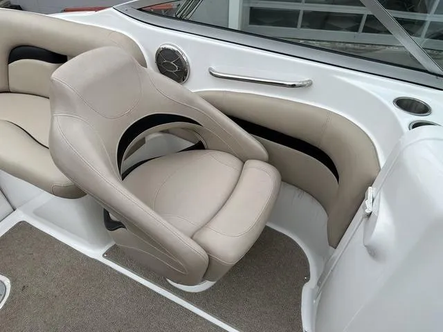 Slide: The Image of 2015 Hurricane SD 2400 I/O boat interior with beige seating and speaker detail. - 19