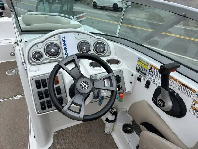 Slide: The Image of 2015 Hurricane SD 2400 I/O boat dashboard with steering wheel and control panel. - 21