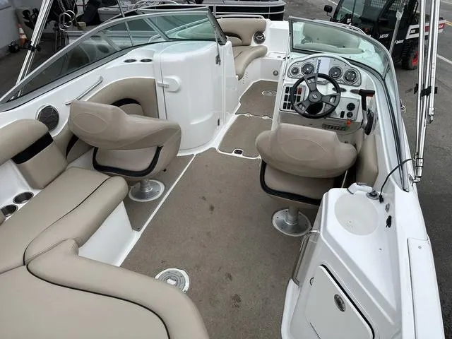 Slide: The Image of 2015 Hurricane SD 2400 I/O boat interior with beige seating and modern dashboard. - 24