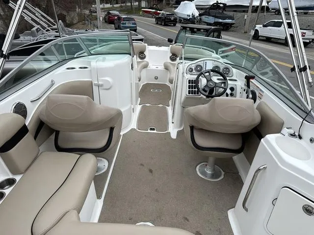 Slide: The Image of 2015 Hurricane SD 2400 I/O boat interior with beige seating and steering console. - 25