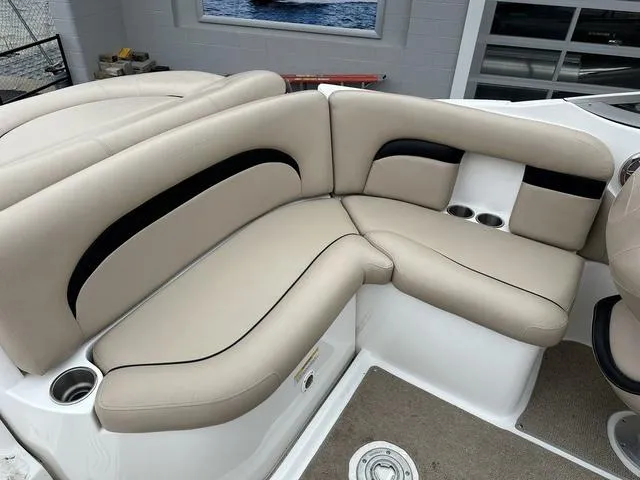 Slide: The Image of 2015 Hurricane SD 2400 I/O boat interior with beige seating and cup holders. - 28